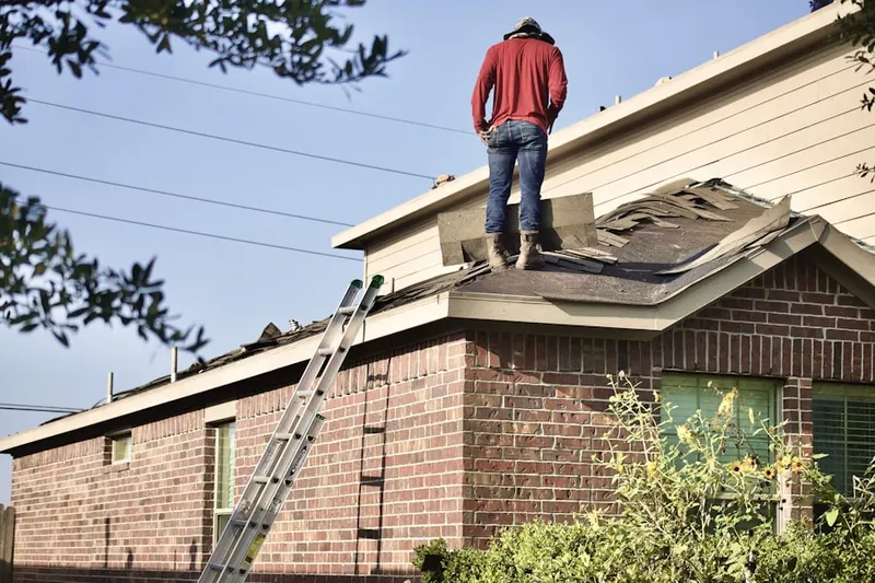 Professional roofer working on a residential roof in Morrison Estates